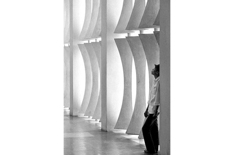 A worker takes a break from cleaning the floor on the ground level of Saigon's Independence Palace, which had just undergone a four-year renovation project.