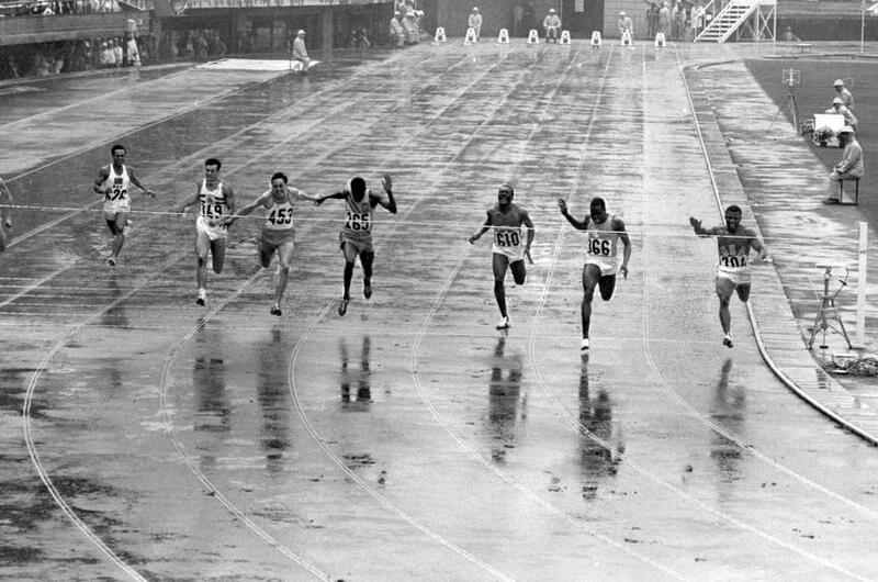 U.S. team member and Army Sgt. Mel Pender (right) wins his qualifying heat in the men’s 100 meters.