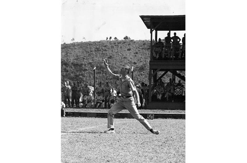 BATON TWIRLER 1st Lt. William E. Modlin, Headquarters, 1st Cav. Div., goes through his paces prior to football game between the Cavaliers and Osan AB on the division's 37th anniversary.