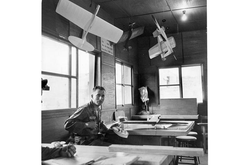 Models of aircraft and boats made by SP4 Karl Breitenstein hang in the recently completed 9th Cav. craft shop. 9/30/1959]; The craft shop is one of the many improvement projects the 1st Recon Squadron has built. The joke in the 1st Reconnaissance Squadron, 9th Cavalry Regiment, 1st Cavalry Division, is that the “recon” in the unit’s name stands for “reconstruction” instead of reconnaissance.” It’s almost true. Since last fall this frontline outfit haws built a steady stream of projects.
