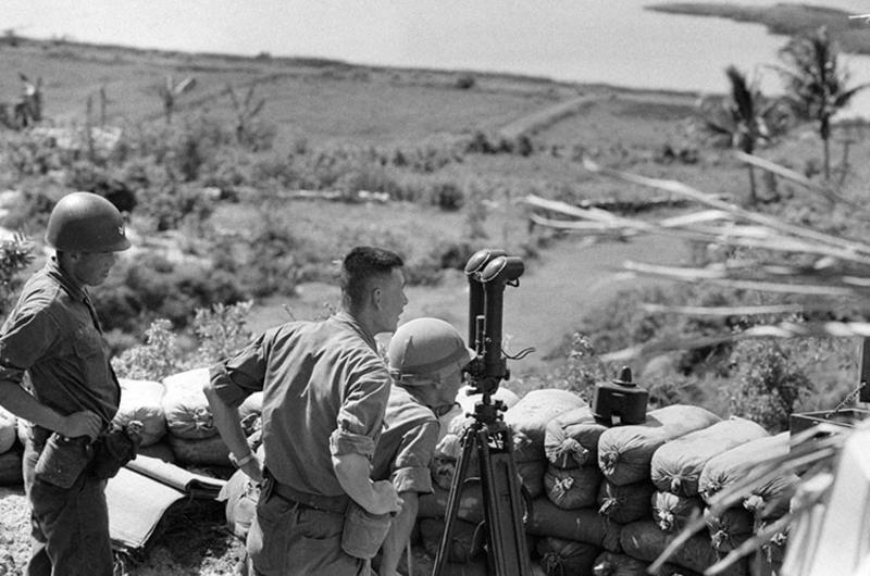 Two soldiers of the 28th RCT watch for Vietcong through telescope.