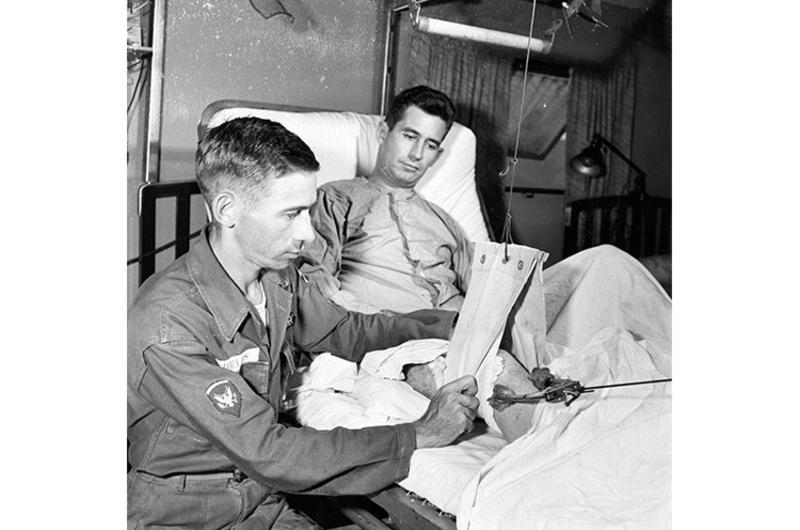 SP2 Wilford Shields checks Russell Traction on patient. The 121st Evacuation Hospital in South Korea – commanded by Maj. Thomas G. Nelson – admits nearly 700 patients a month through its doors for resident treatment.