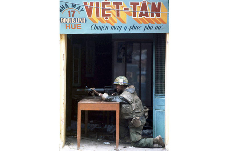 A U.S. Marine takes aim at the enemy from a storefront during the fierce, monthlong battle for Hue, the onetime seat of the Nguyen dynasty and pre-World War II capital of Vietnam.