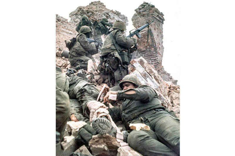 A corpsman treats a wounded U.S. Marine amid the rubble of the Dong Ba Tower during the hard-fought battle for control of Hue's citadel.