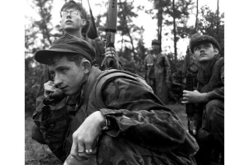 Squad leader Cpl. Mike Roseberry of Paducah, Ky., calls in gunships as Marines from CUPP6, Golf Co., 5th Marine Regiment, and Popular Forces from Huong Xuan Village come under fire near Combat Base Baldy, about 27 miles southeast of Da Nang.