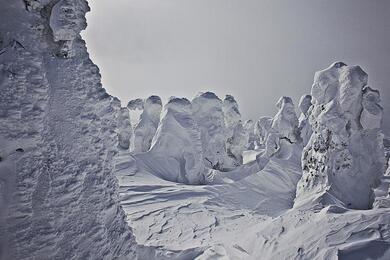 A barren landscape of what looks like snowy hills. 