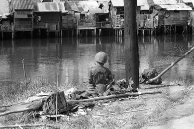 ARVN national police and rangers are clearing out pockets of VC snipers near Newport Bridge on the northern outskirts of Saigon.