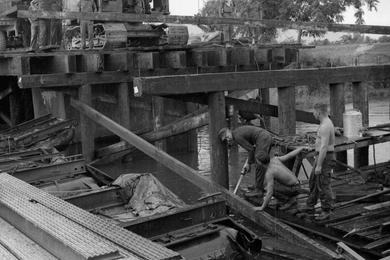 Seabees build a timber bridge near Phu Bai, Vietnam.
