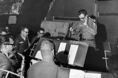 Band practice is conducted by CWO Benjamin J. Cortese in a building adjacent to the billets.