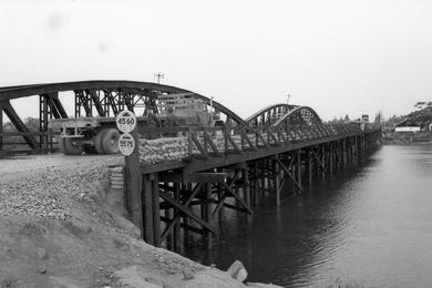 Typical Seabeem road building and bridge projects on Route 1 between Phu Loc and Hue, the old capital.; Trucks pass a Seabee-built bridge on Route.
