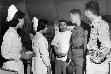 Dr. (Captain) Vernon J. Hendrix talks to the doctors and nurses at the 77th Army Hospital near Kwangju. He knows the medical problems in his area through trips he has made to six provincial hospitals not too far from Sang Mu Dae, where he is attached as the medical officer of Detachment K, U.S. Army Advisory Group, South Korea.