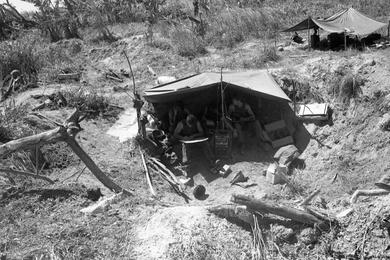 Marines of 2nd Battalion, 1st Regiment, 1st Marine Division are taking a break from the hot sun underneath a tarp before heading out on a sweep of Go Noi Island.