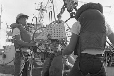 Transfer of personnel by high-lines onto the USS Buchanan.The USS Tappahannock - a refueling tanker - is visible in the background.