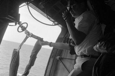 On board a helicopter as it approaches the aircraft carrier USS America during Operation Sea Dragon.