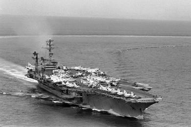 Aerial view of the USS America. Air planes line the flight deck of the aircraft carrier as it participates in Operation Sea Dragon of the North Vietnames shore.