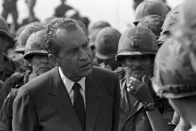 President Richard Nixon chats and shakes hands with the men at the 1st Infantry Division's Di An base camp in South Vietnam.