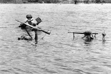 Leatherneck stands tall while crossing river during Operation Beacon Guide north of Da Nang.