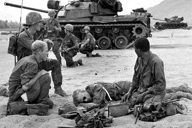 Two tanks from 1st Platoon, A Company, 60th Armored Cavalry move in to help soldiers shield a wounded comrade