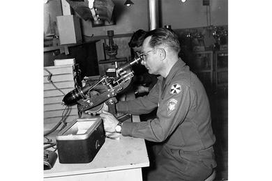 MICROSCOPE IS REPAIRED by SP6 Joseph Torrecello, technician at the 6th Medical Depot at Ascom, Korea.
