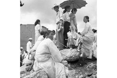 ANXIOUS HOURS - Korean nationals sideline the Seoul reception point for South Korean repatriated prisoners of war trying to find relatives among the returning ROKs.