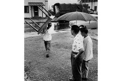Rain fails to stop moving men from bringing furniture.