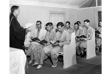 Chaplain George E. Fort holds Sunday service for hospital patients.