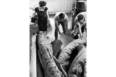 Choosing right rug is up to Mrs. Van Dyne. Margaret, wife of Air Force SSgt. Arthur Van Dyne of the 6002nd Air Intelligence Sv. Gp. has two servicemembers show her the various rug options.