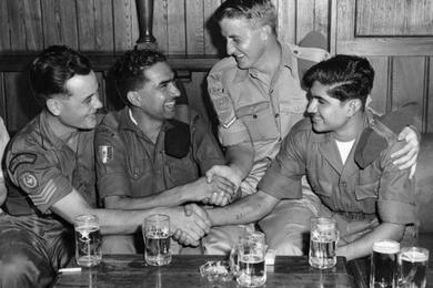 four people are shaking hands.
