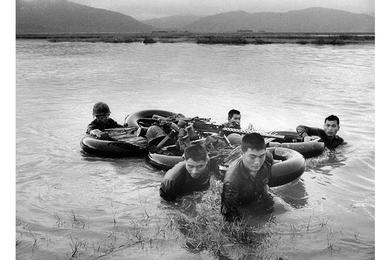 ROK troops use raft of 6 inner tubes to float equipment across river in Tuy Hoa Valley.