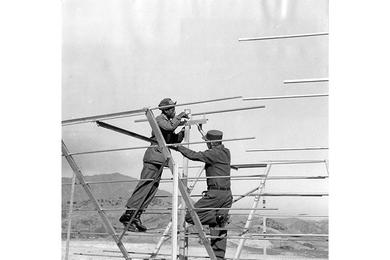 Antenna for new AFKN TV station located at Camp Kaiser. 7th Inf. Div., Korea, is prepared for installation by SP4 Willie F. Correllies (left) and Cpl. John Darcy. The new station, which will transmit filmed programs, is the first of its kind set up outside Seoul.