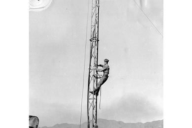 Station tower is worked on by SP4 Ferenc Arval. The new station is operated by men from the AFKN unit in Seoul.