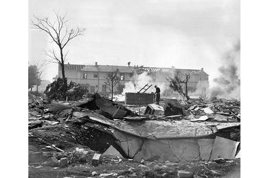 Wrecking crews tear down former dependent housing units in the 500 block of the Washington Heights Housing Area to make room for facilities which will be used in the 1964 Olympics.