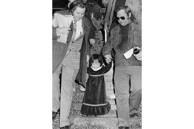 A beaming Kim Yon Jin - now Jenny Jones - is led down a stairway at Tokyo International Airport Tuesday by Pacific Stars and Stripes Hal Drake (left) and Jim Lea.