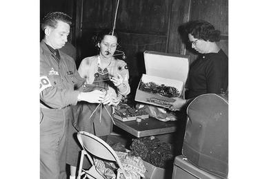 Getting into the Mood for the Christmas season, this USO group puts special touches to holiday decorations at the Seoul USO.