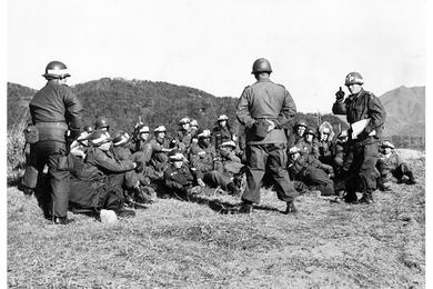 Combat military police are briefed on road traffic control. Class in traffic control is given by Capt. Edward Kupec. 7th Infantry Division troops jumped off from rear assembly areas in below freezing weather Wednesday morning, December 16th, and moved into positions in the third day of maneuvers in exercise Mobex Hardstand.