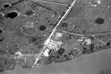 Aerial view of a destroyed bridge as Linda Giese of San Mateo, California flies over South Vietnam on her way to visit the 1st Battalion, 327th Infantry Regiment, 101st Airborne Division near Phu Loc, Vietnam.