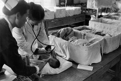 Dr. Wong Ok Ja examines one of the many babies in a ward located in the old section of the hospital.