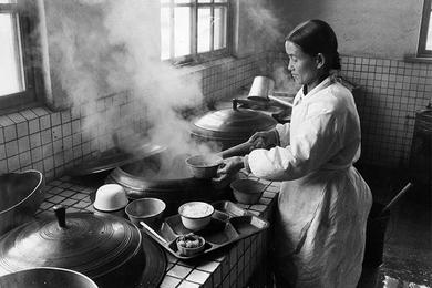 An woman prepares food trays for the patients in the kitchen of the Seoul Children’s Relief Hospital.