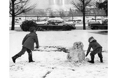 Children in Tokyo's Washington Heights Dependent Housing Area get in some old-fashioned snow fun as the first real snow of the winter fell in Tokyo Sunday.
