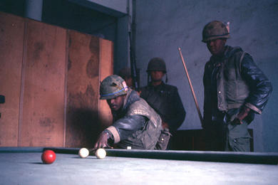 U.S. Marines take advantage of a lull in fighting to play some billiards on a billiards table found inside a building in Hue city.