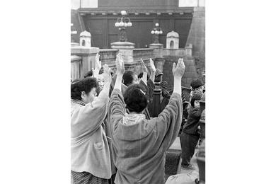 A group of rejoicing women offer "Banzais" in front of the Imperial Palace