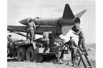 Honest John Rocket is prepared for firing by men of D Battery, 1st Field Artillery Battalion, 31st Artillery Regiment of the 7th U.S. Infantry Division, at Camp St. Barbara, Korea.