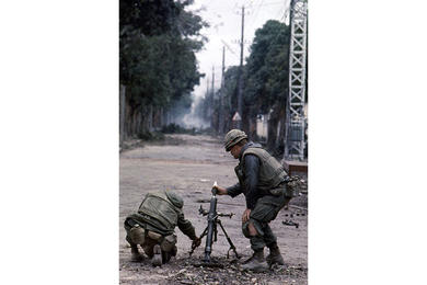 Two Marines ready a mortar in the middle of a Hue street.