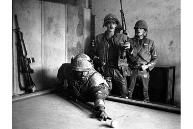 During the lengthy battle for control of the old Vietnamese national capital city of Hue, weary U.S. Marines manage to find a few minutes to relax.
