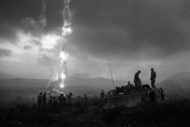 Flares light up the darkening sky over Que Son Valley, silhouetting the men from B Company, 2nd Battalion, 12th Cavalry Regiment against the mountains.