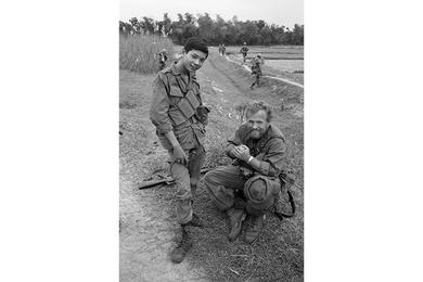 UPI photographer William 'Bill' Hall talks to a cavalryman who wears the nametag Kindness.