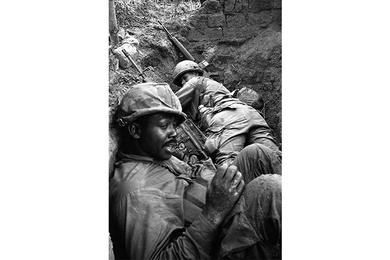 Two cavalrymen take cover in a large ditch during a sweep operation through Que Son Valley.