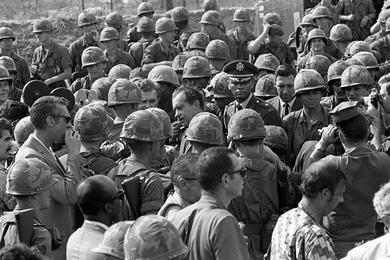 President Richard Nixon chats and shakes hands with the men at the 1st Infantry Division's Di An base camp in South Vietnam.