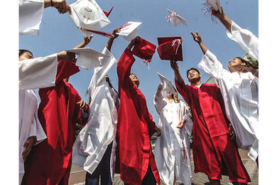 Graduating seniors from Nile C. Kinnick High School toss their caps into the air as they mark the beginning of a new phase of their lives.