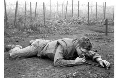 Just outside of the beleaguered Khe Sanh base's outer defenses, Hospital Corpsman Theodore Rutkowski of Pittsburgh uses a stethoscope to listen for signs of Viet Cong tunneling.